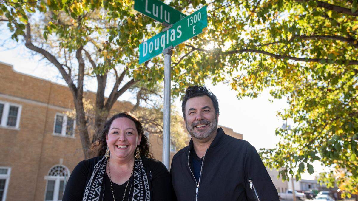 Heather Siefer and Bruce Rowley stand at the corner of Lulu and Douglas. After an impromptu brainstorming session, they decided it would be fun to name the area, which includes other streets named for women, the Daughter District.
