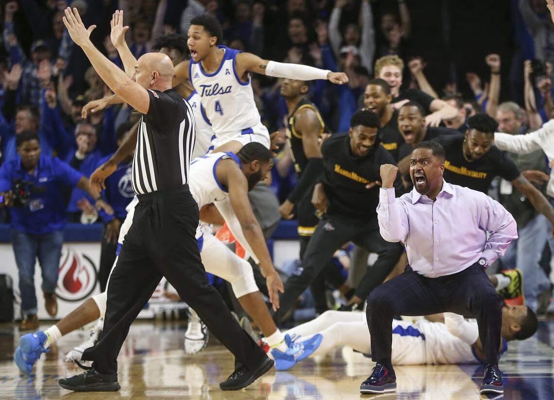 Tulsa coach Frank Haith, right, reacts after Tulsa guard Elijah Joiner, behind Haith on the floor, hit a three-pointer at the buzzer to beat 23rd-ranked Wichita State 54-51 on Saturday in Tulsa.