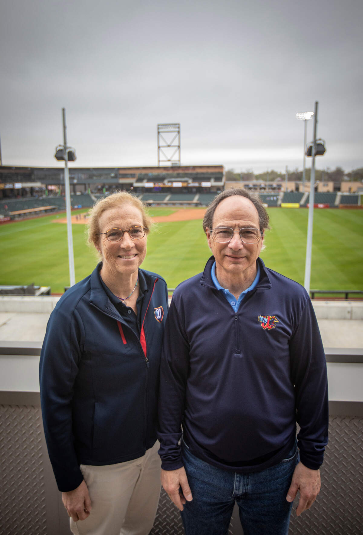Wichita Wind Surge partners Jane Schwechheimer and Jordan Kobritz are pictured before a recent day game at Riverfront Stadium. Kobritz, CEO, and Schwechheimer are leading the ball club since the 2020 COVID-19 death of Lou Schwechheimer, Jane Schwechheimer’s husband and the team’s founder.