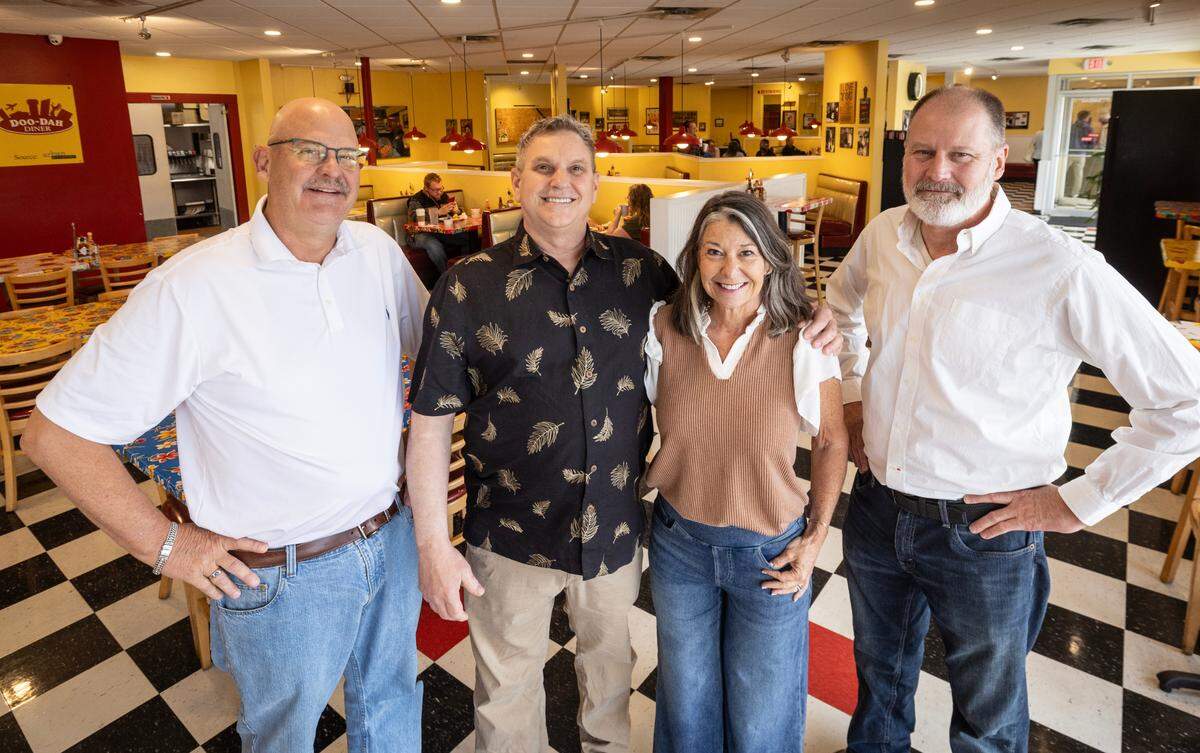 Jeff Miller, left, and his brother Jay, right, will take over ownership of the famed Doo-Dah Diner from founders Patrick and Timirie Shibley. The Millers are the owners of Wichita’s Five Guys Burgers & Fries restaurants.