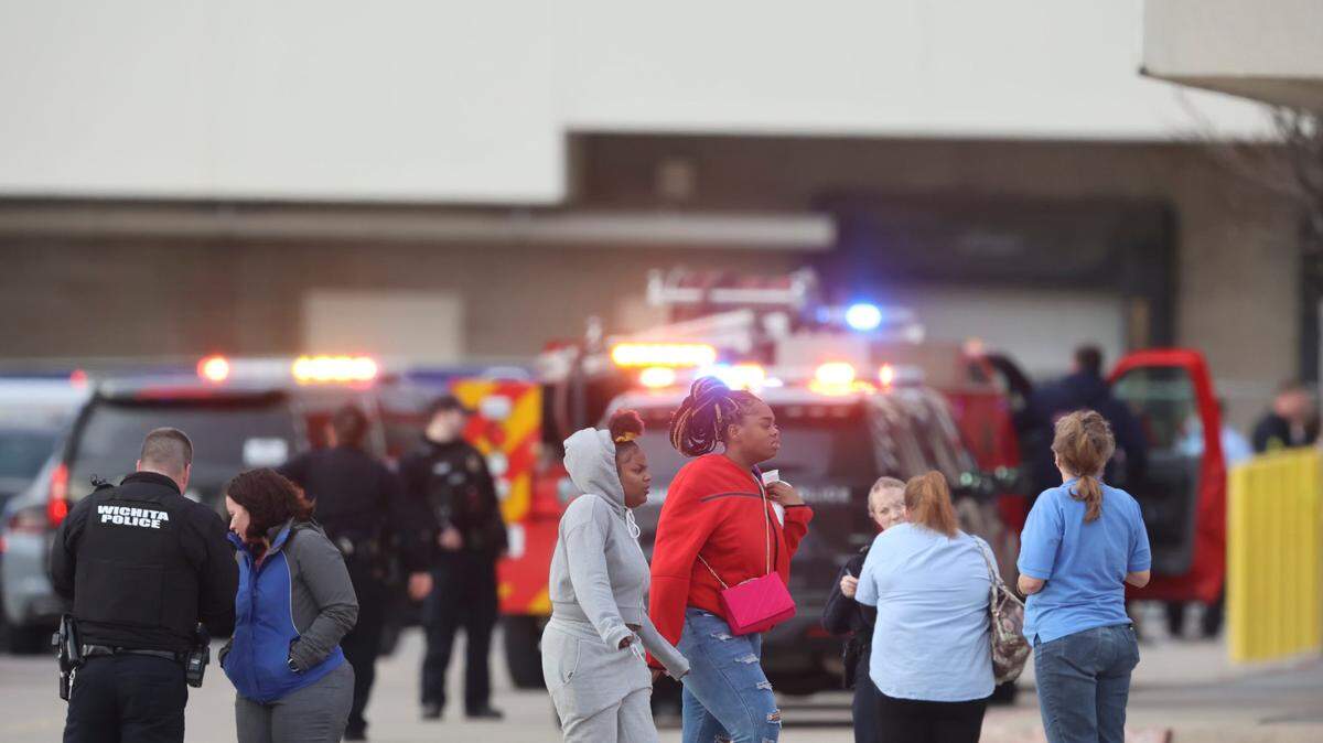 A group of people leave Towne East Mall where Wichita police investigated a shooting on March 18, 2022.