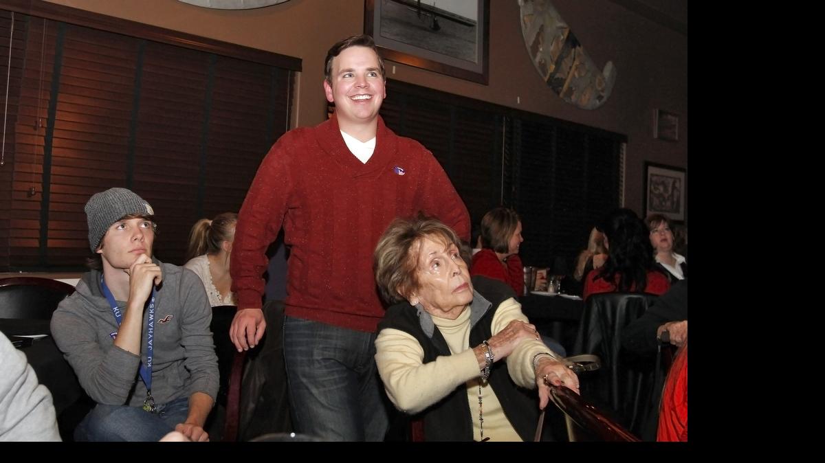 A smile comes across Michael O'Donnell's face, center, as  he watches results come in for his race for Kansas Senate, Tuesday night at the Hangar One Steakhouse.
