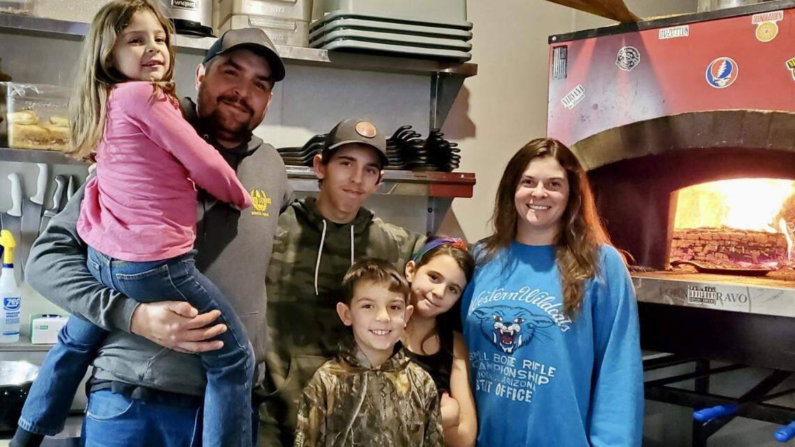 The Biggs family moved to Kansas from California in 2019. Last year, they opened Halagains, a popular bar and grill in tiny Garden Plain that specializes in wood-fired pizza, sandwiches and skillets. Pictured at the restaurant are, from left, Andi, Shad, Aaron, Abel, Adaline and Stephanie.