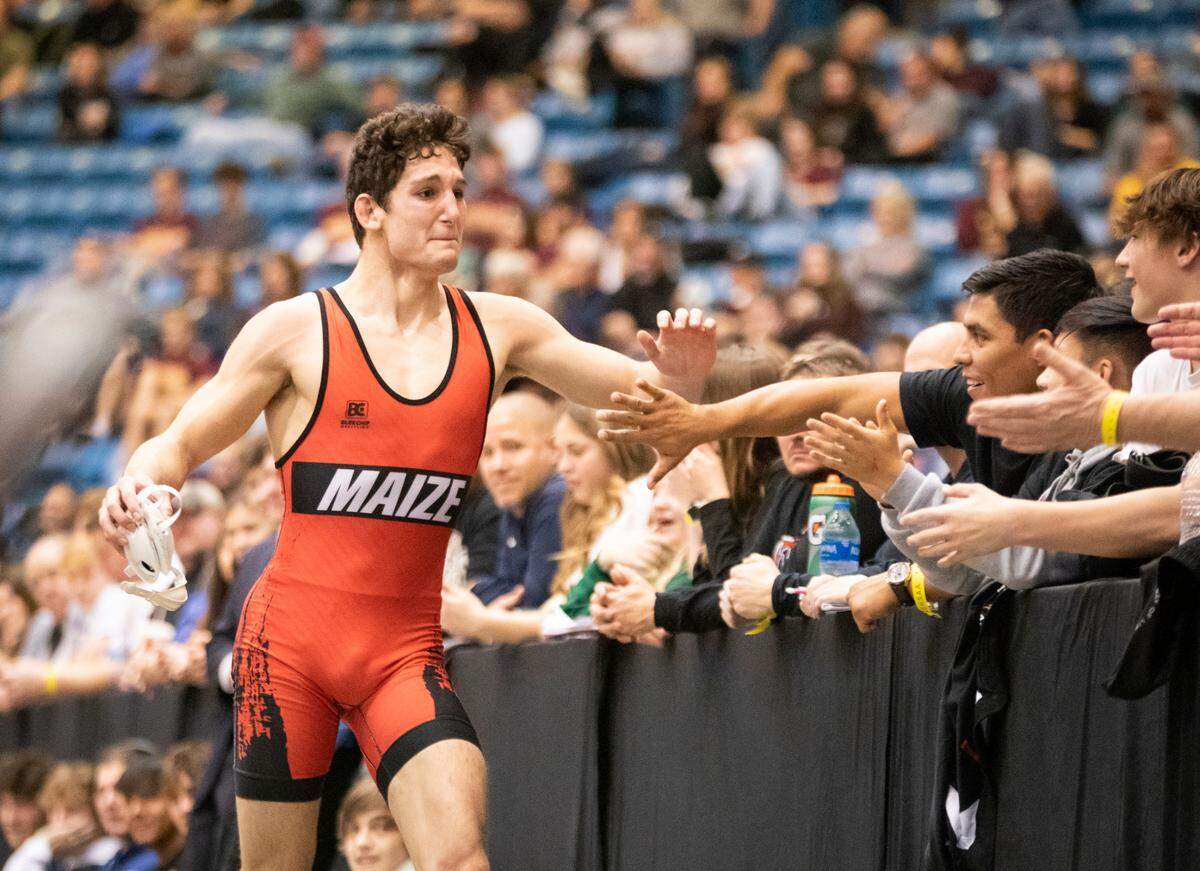 Maize’s Connor Padgett celebrates with the crowd after winning a Class 5A state championship.
