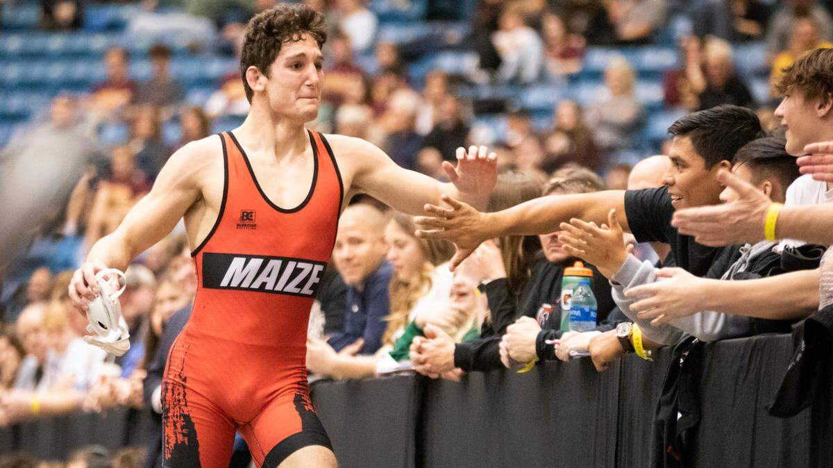 Maize’s Connor Padgett celebrates with the crowd after winning a Class 5A state championship.