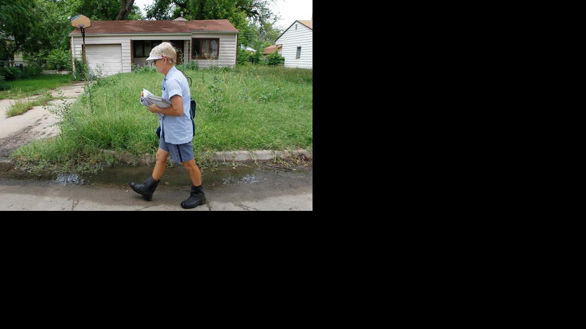 A postal worker decides to walk around the yard at a house northeast of Meridian and Pawnee. “I don’t like walking through that yard, especially when it’s wet,” she said. City inspectors recently cited the owner of the house for allowing the grass and weeds to exceed the 12-inch limit. (June 28, 2014)

