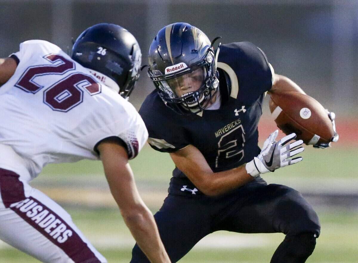 Maize South’s Corey Minks (2) tries to evade Buhler’s Sam Cruz (26) as he looks to gains yardage in the second quarter at Maize South Friday. (Sept. 22, 2017)