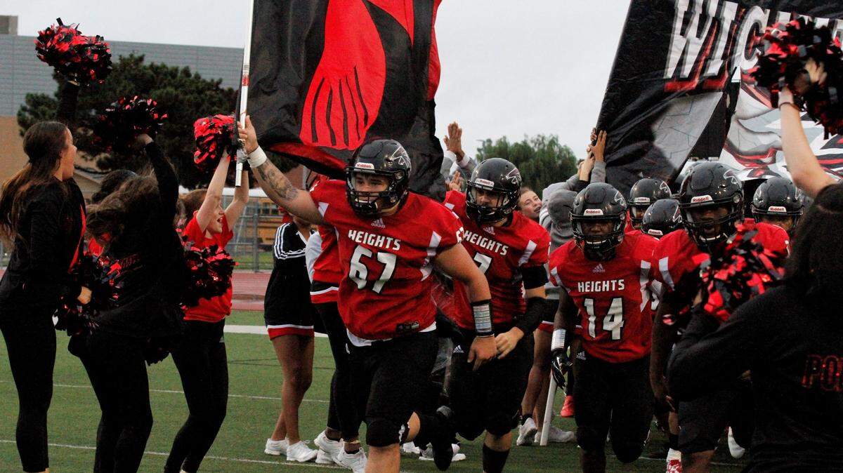 Wichita Heights comes onto the field for its game against Bishop Carroll in the Golden Eagles’ 36-20 win over the Falcons on Friday. (Sept. 7, 2018)