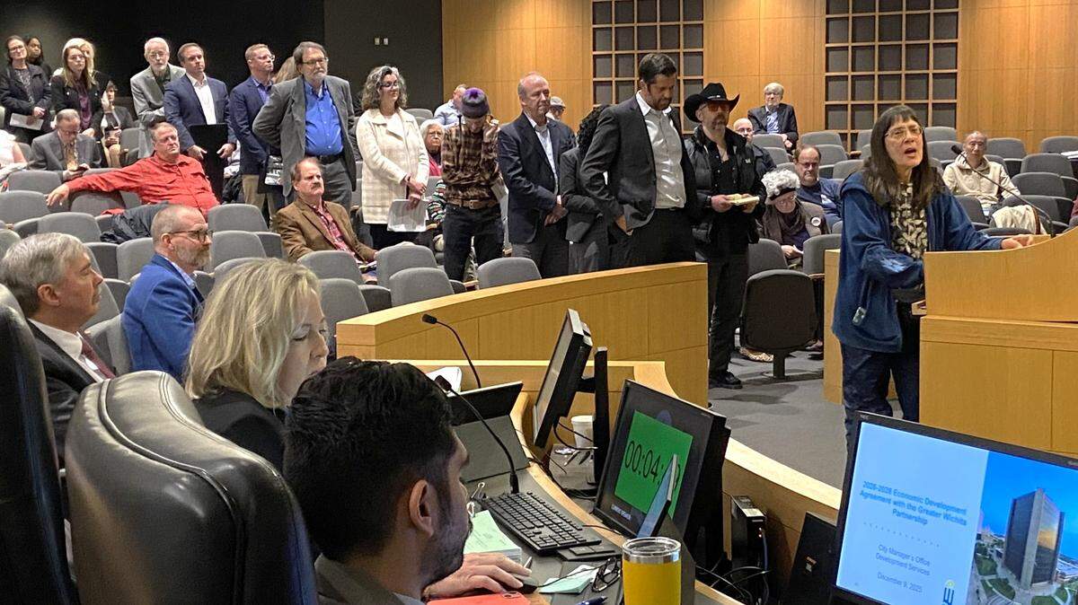 As Wichita activist Janice Bradley addresses the City Council on Tuesday on a proposed 1% sales tax, residents form a long line behind her waiting for their turn to speak.