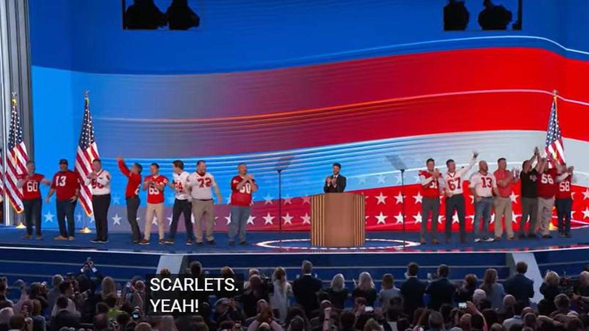 Fifteen former football players who Tim Walz coached appeared onstage shortly before his speech accepting the Democratic nomination for vice president.