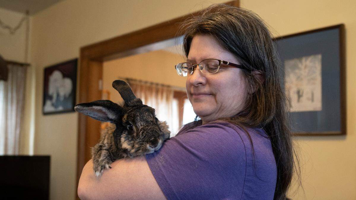 Joan Gedraitis, the executive director and senior caretaker for bunnies at Bunny TNT, holds a rescue rabbit named Cadbury in her College Hill home. Bunny TNT is a rescue organization in Wichita.