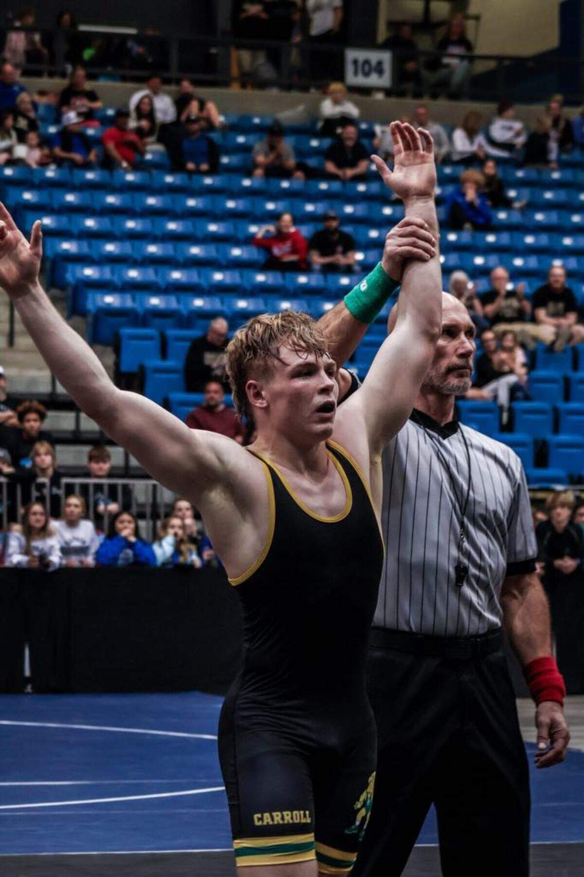 Bishop Carroll senior Brady Duling has his hand raised by the official after becoming a Class 5A state champion this past Saturday at Park City Arena.