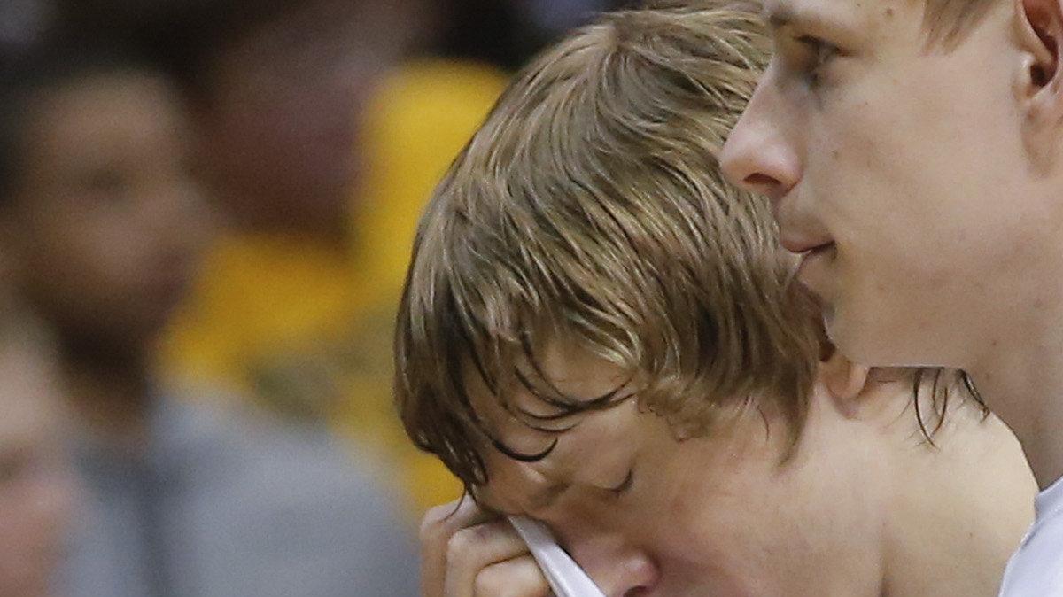 Wichita State's Ron Baker holds back tears as he walks off the court with teammate Zach Bush after the Shocker's lost to Kentucky in the third round of the NCAA Tournament, 78-76, ending their historic season at 35-1.