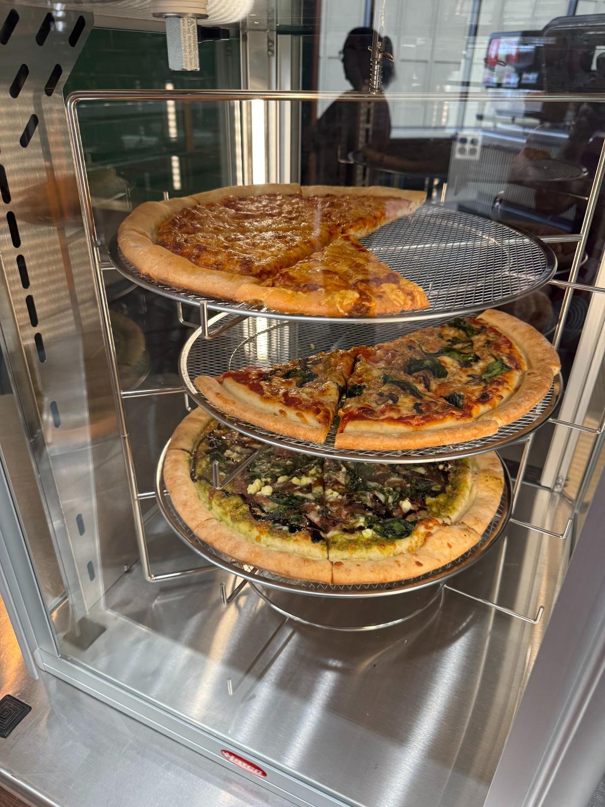 Pizza by the slice is one of the options for customers at the new Plentibloom Cafe & Market inside the Ruffin Building, Douglas and Broadway. It opens to the public on Monday.
