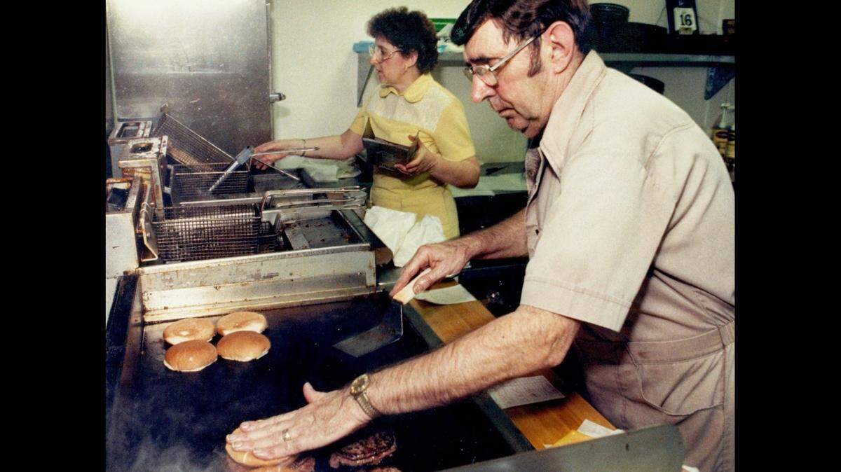 Bill Stratton, foreground, and his wife, Mary Stratton, are pictured in 1989 inside their restaurant, Bill’s Big 6, after it had moved to 424 E. Central.