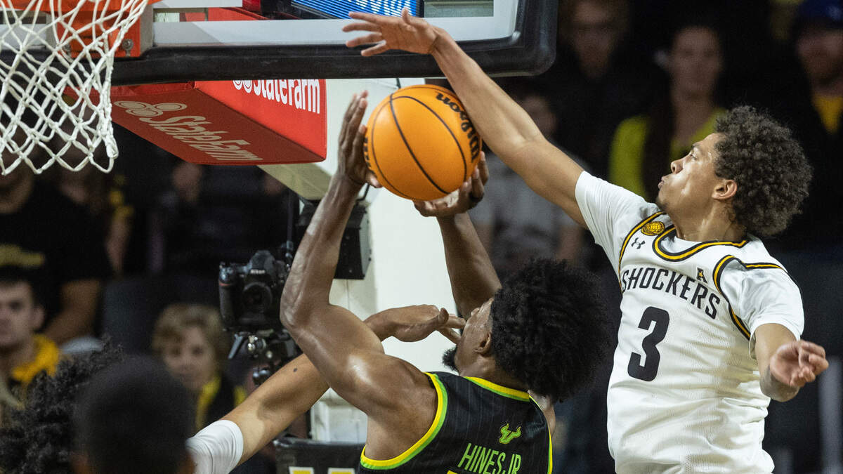 Wichita State’s Craig Porter Jr., blocks the shot of South Florida’s Sam Hines Jr. on Sunday.