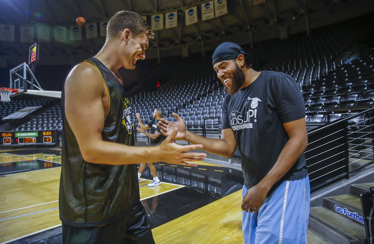 Garrett Stutz, who played at WSU from 2008-12, greets former teammate J.T. Durley, who played at WSU from 2006-11, at the Aftershocks’ first practice on Monday at Koch Arena.