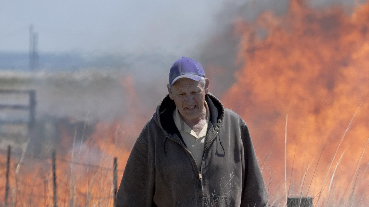 Clenton Owensby, a professor at Kansas State University, lights a pasture fire just south of Manhattan on Tuesday. The EPA may change regulations on range burning due to ozone issues in nearby urban areas due to the smoke from the fires. Owensby is considered an expert on pasture burning and range management issues. (April 27, 2010)