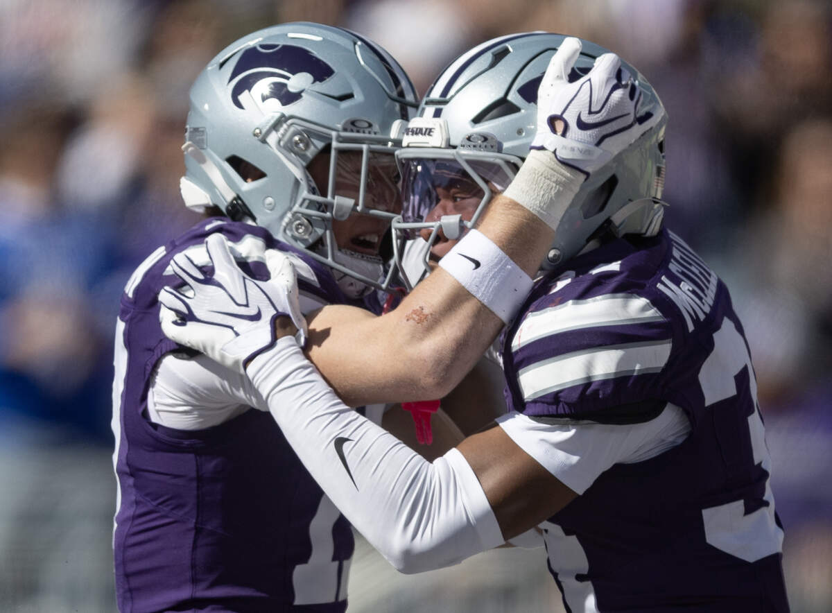 Kansas State cornerback Nick McClellan celebrates with teammate Mikey Bergeron after McClellan forced a safety during the first half of their game against Kansas in Manhattan on Saturday.