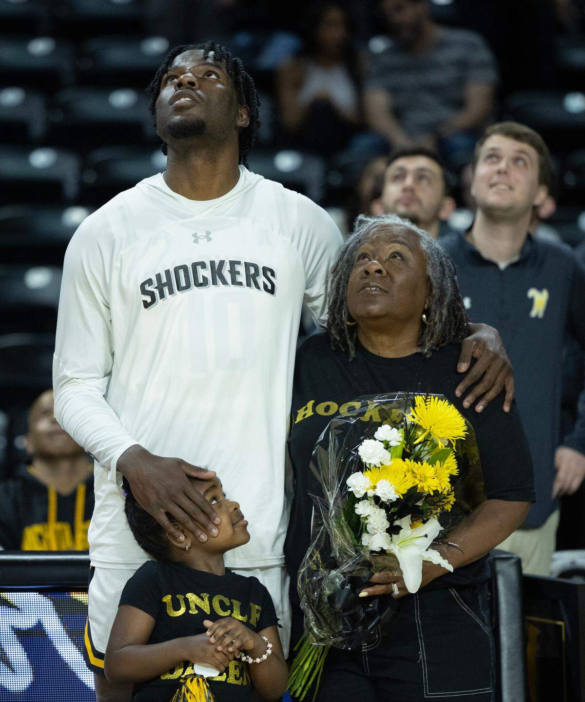 Wichita State senior Dalen Ridgnal watches his senior-day ceremony video with his aunt, Charmain Ridgnal-Wright, and his niece at Koch Arena.