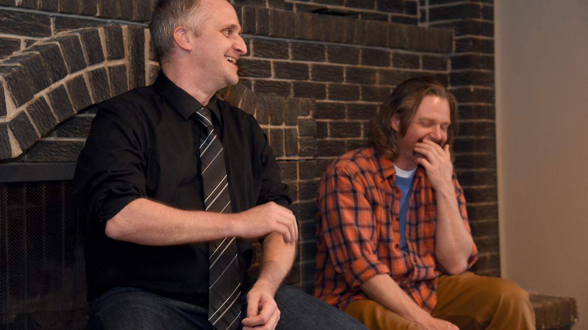 Trevis Williams laughs (right) as Brandon Scrimsher shows his humor during a meeting at the Artists Helping the Homeless residency in Lawrence recently. Photo by Dave Kaup