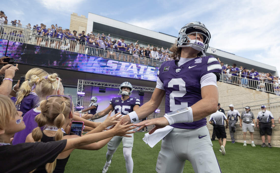 Avery Johnson high-fiving fans at 2026 K-State season opener
