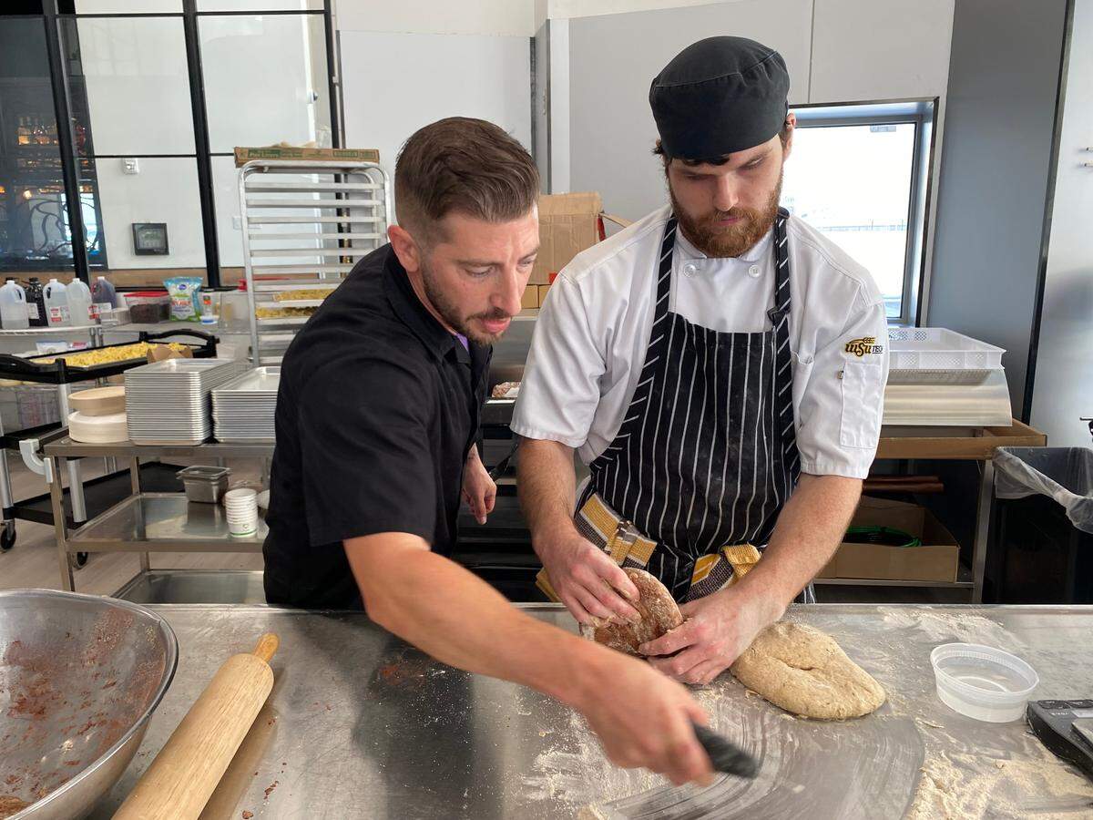 Chef Bill Crites helps culinary student Charles Wilks prepare fresh bread at The Bistro, the new student-staffed restaurant that opens today at Niche in downtown Wichita.