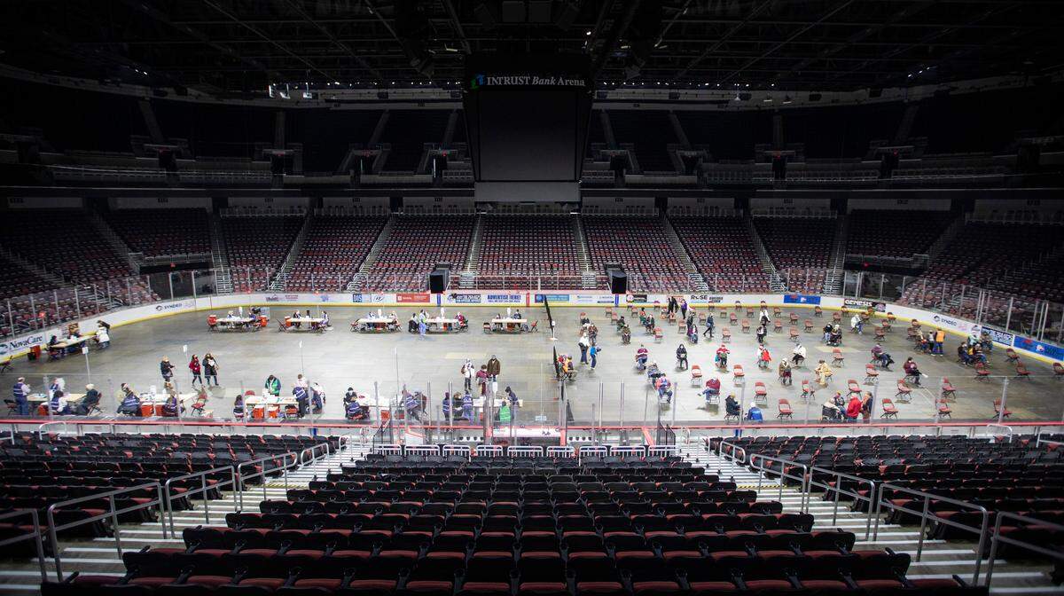 Sedgwick County’s COVID-19 vaccination station at Intrust Bank Arena has moved to the covered up hockey ice floor opening up a lot more space so people can wait inside during the frigid temperatures. The shots were previously being given in the concourse with an outdoor overflow. (February 9, 2021)
