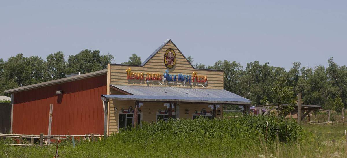 Park City paid $3 million to help develop the Wild West World theme park in 2007. It closed two months after it opened and was overrun with weeds a year later when this photo was taken. The buildings have since been auctioned off, removed, and scattered around south-central Kansas.