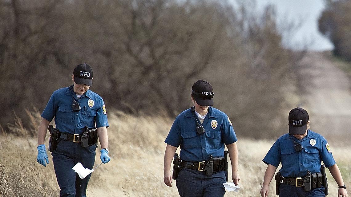 Wichita Police Cadets on foot and five WPD officers on horseback searched Tuesday along a gravel road leading to a house where a Valley Center-area couple were shot Friday night. (Nov. 19, 2013)