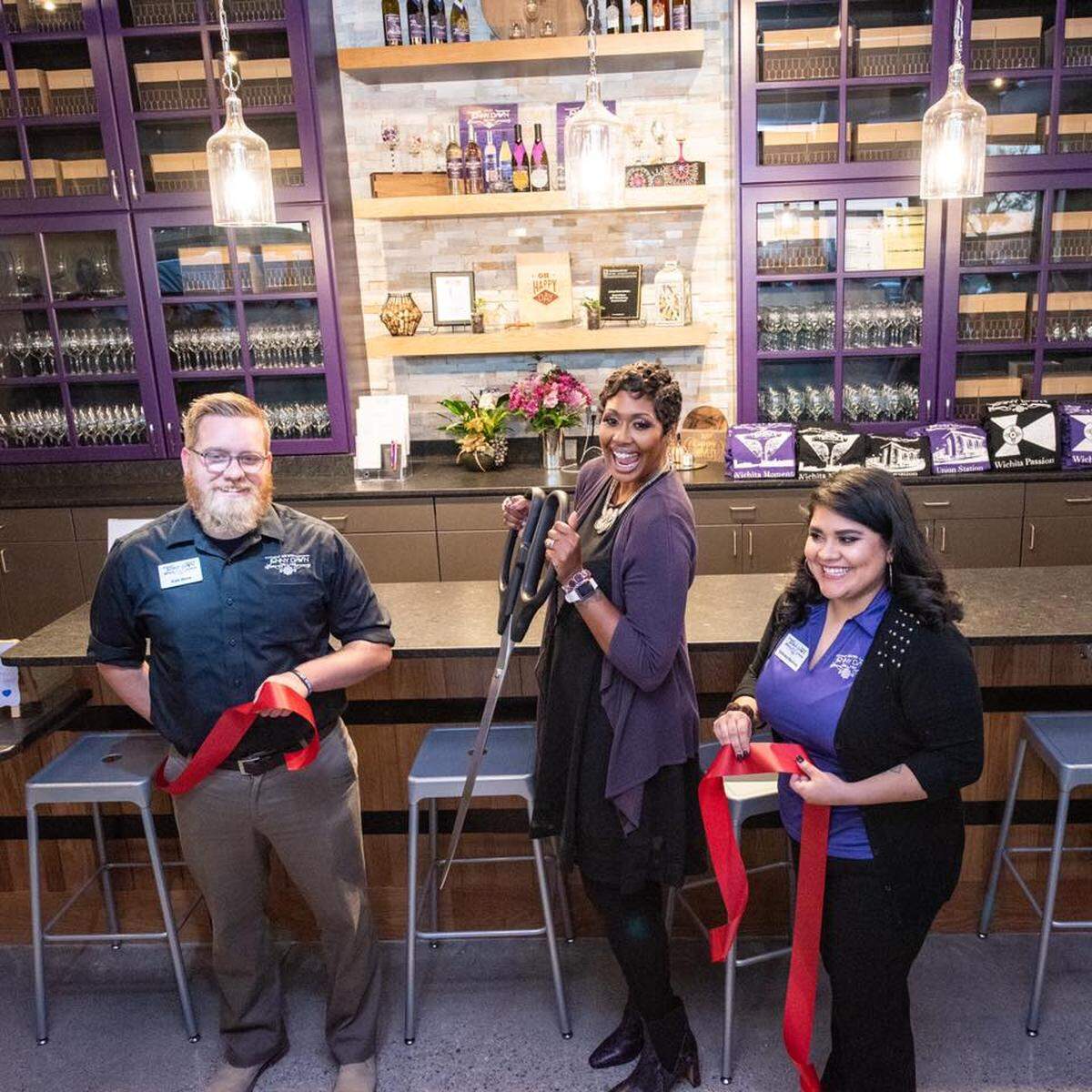 Jenny Dawn Cellars owner Jennifer McDonald, center, at the ribbon cutting for her new business