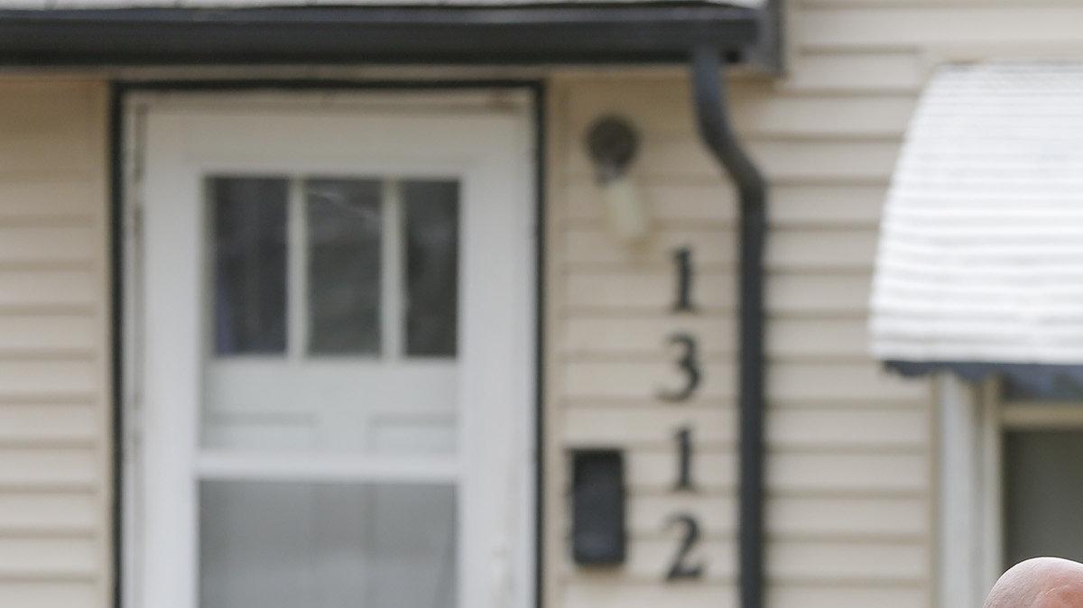 Two Wichita police officers stand in front of a home where a 1-year-old was reportedly shot on Tuesday.