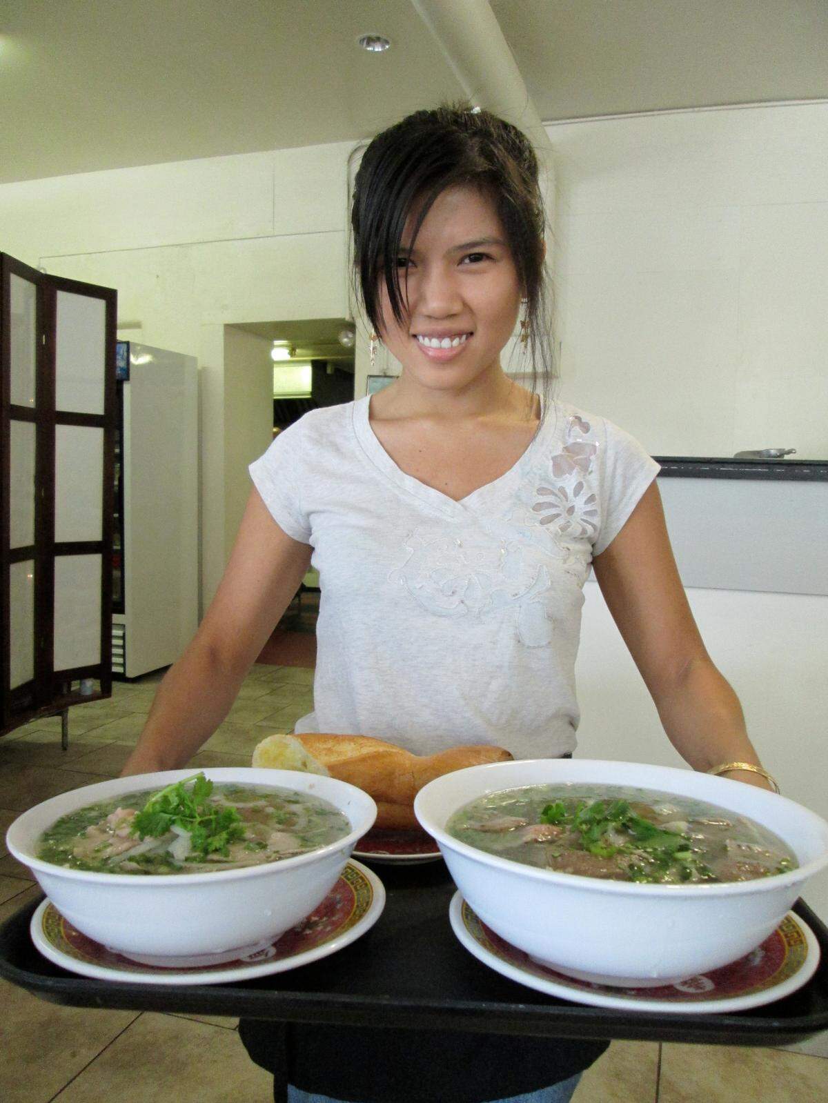 My husband took this picture of My Tho waitress Dung Nguyen as she delivered orders of pho, the former restaurant’s signature soup. Though I always was more of a beef stew fan, it’s almost hard to look at this photo because of how much I long for this pho and that crusty French bread.