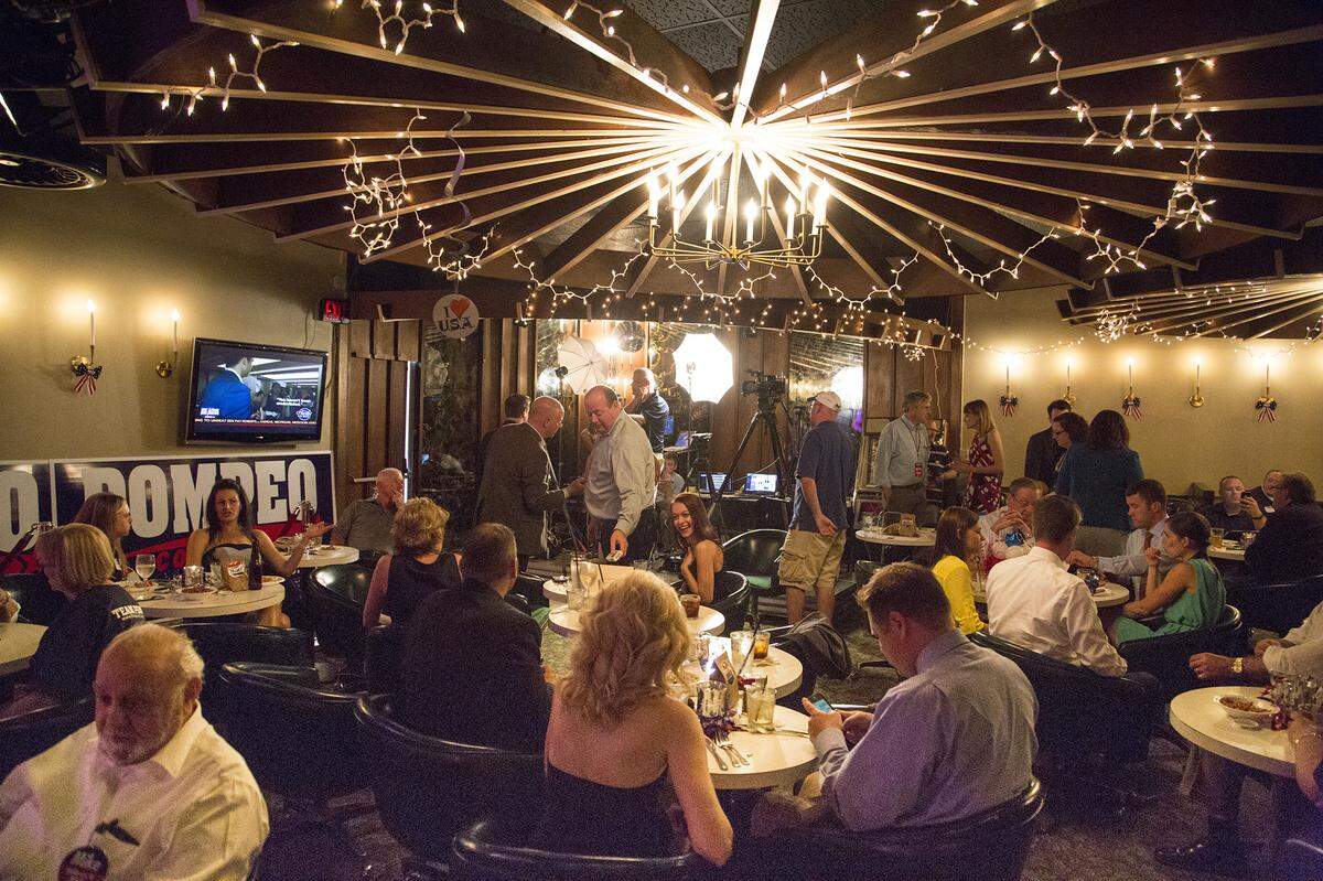 One of the Candle Club’s well-known wagon wheels, strung with party lights, back when it had a candelabra hanging from it during a Mike Pompeo watch party in early 2014.