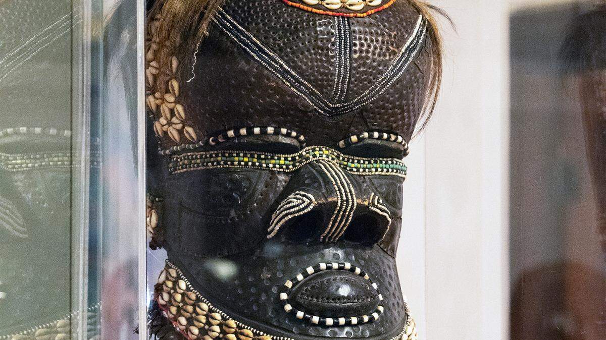 The bwoom helmet mask on display at The Kansas African American Museum would have been used for ritual ceremonies by the Kuba kingdom in what today is known as the Democratic Republic of the Congo. The mask is made with tinted wood and carved metal adorned with cowrie shells, glass beads, seed pods and other natural materials.