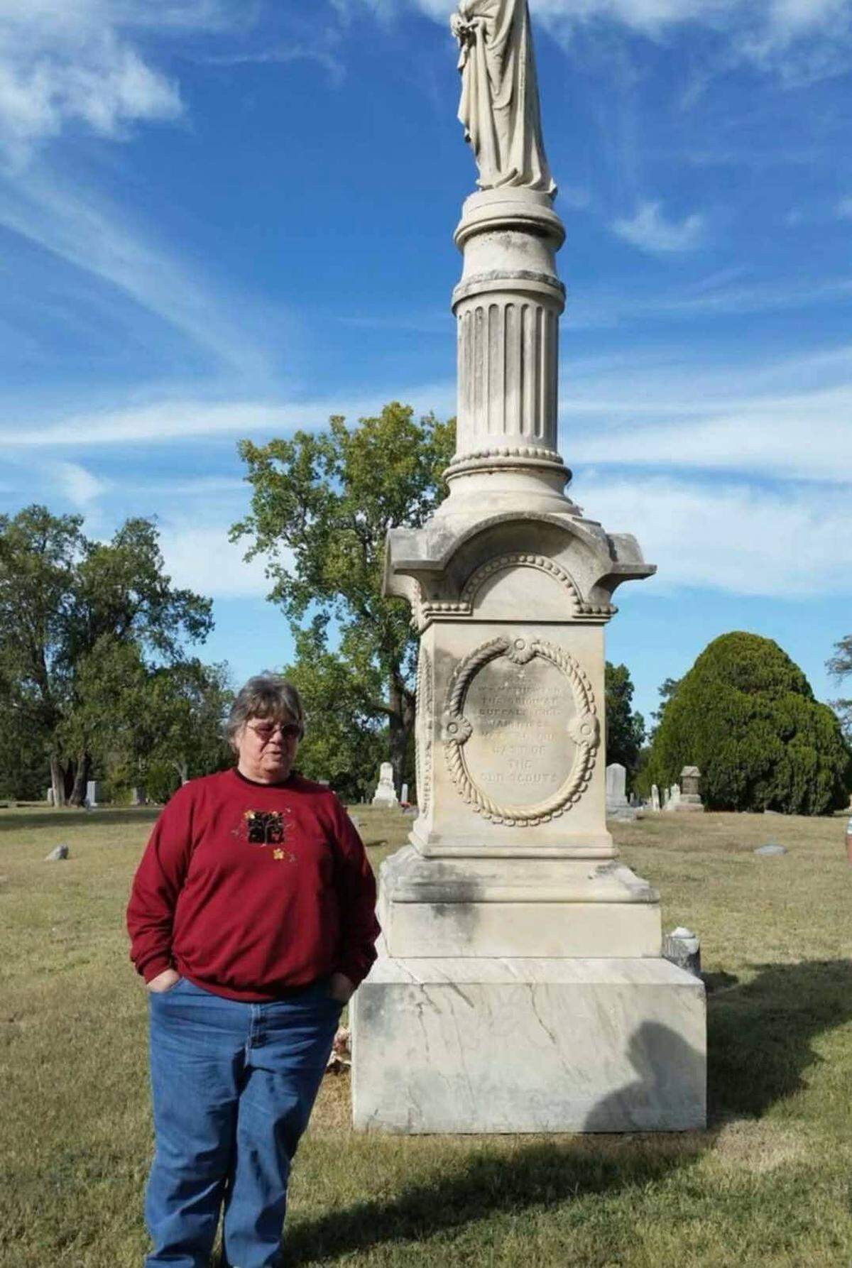 Barb Myers’ mother, Mary Myers, poses for a photo alongside the grave of William “Buffalo Bill” Mathewson at Highland Cemetery. The photo, taken 10 years ago, was one of the first Barb Myers took in the historic cemetery.