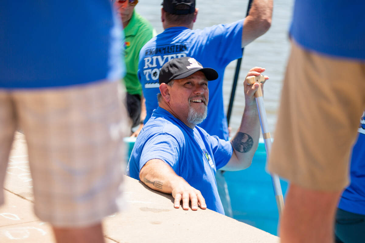 A cowboy bathtub races participant situates himself in the competition’s stock tanks on Saturday before racing across the width of the Arkansas River near Delano.