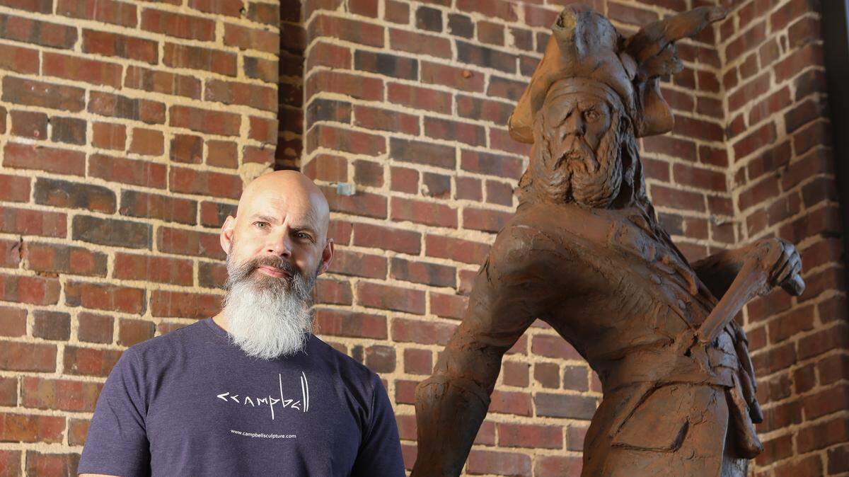 Sculptor Craig Campbell stands next to an 8-foot tall sculpture of Black Beard he created for the History Channel. The statue is on display at the Mud Haus in downtown Wichita. Campbell has worked all over the world creating sculptures for everything from the Sedgwick County Zoo to Peter Jackson movies in New Zealand.