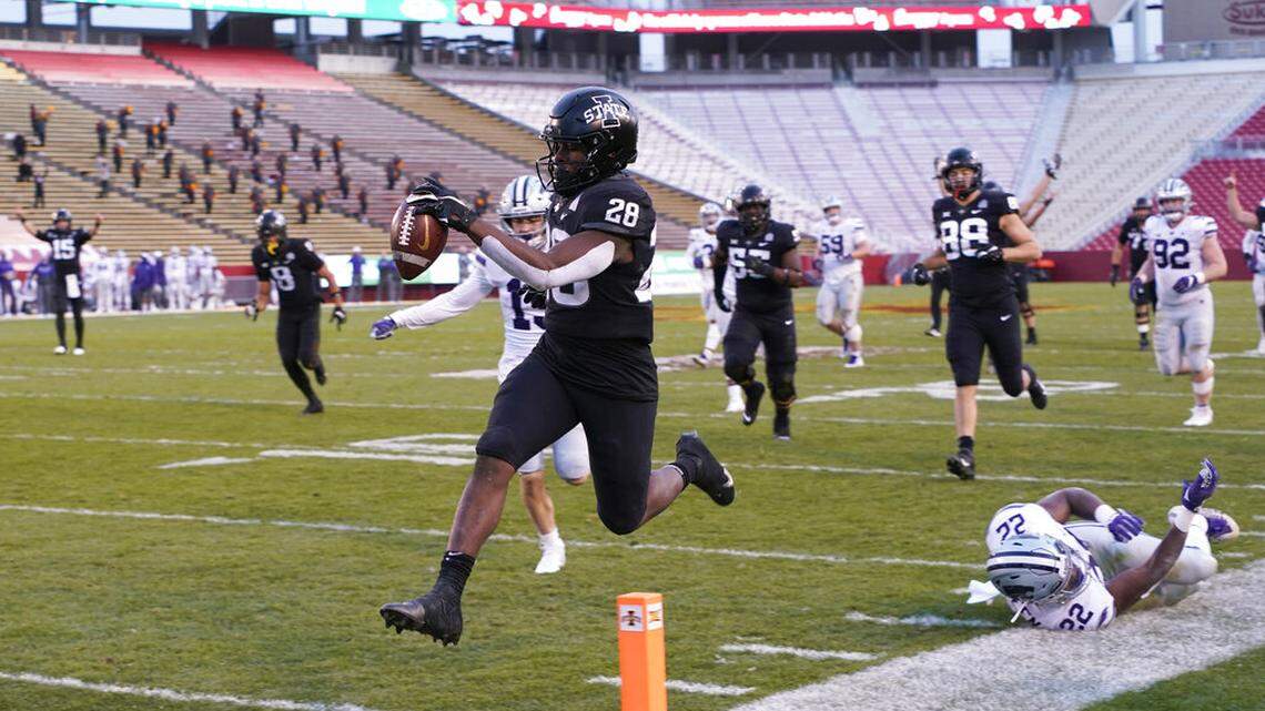 Iowa State running back Breece Hall scores on a 33-yard run ahead of Kansas State linebacker Daniel Green (22) during the first half on Saturday, Nov. 21, 2020, in Ames, Iowa.