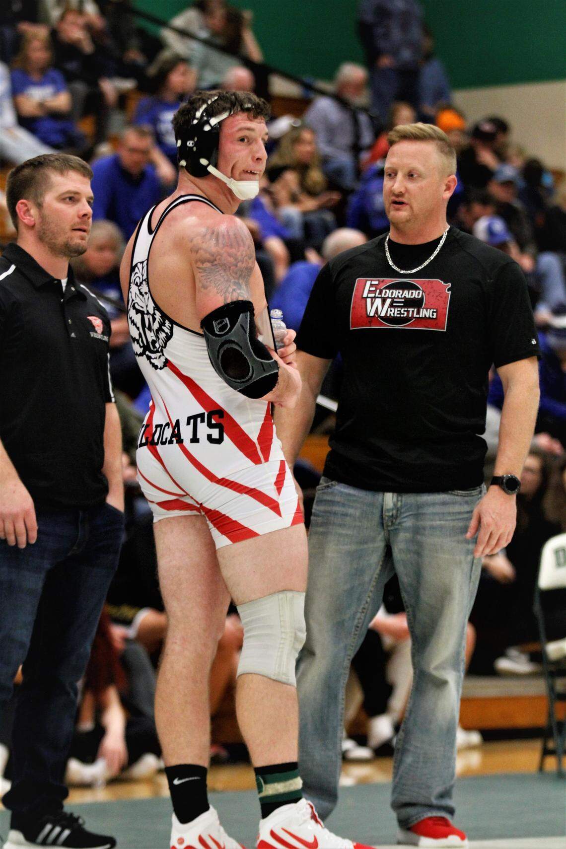 El Dorado 220-pound wrestler Braden Morgan and his coach, Wesley Reynolds, talk during the championship bout of the Derby Invitational. (Jan. 5, 2019)