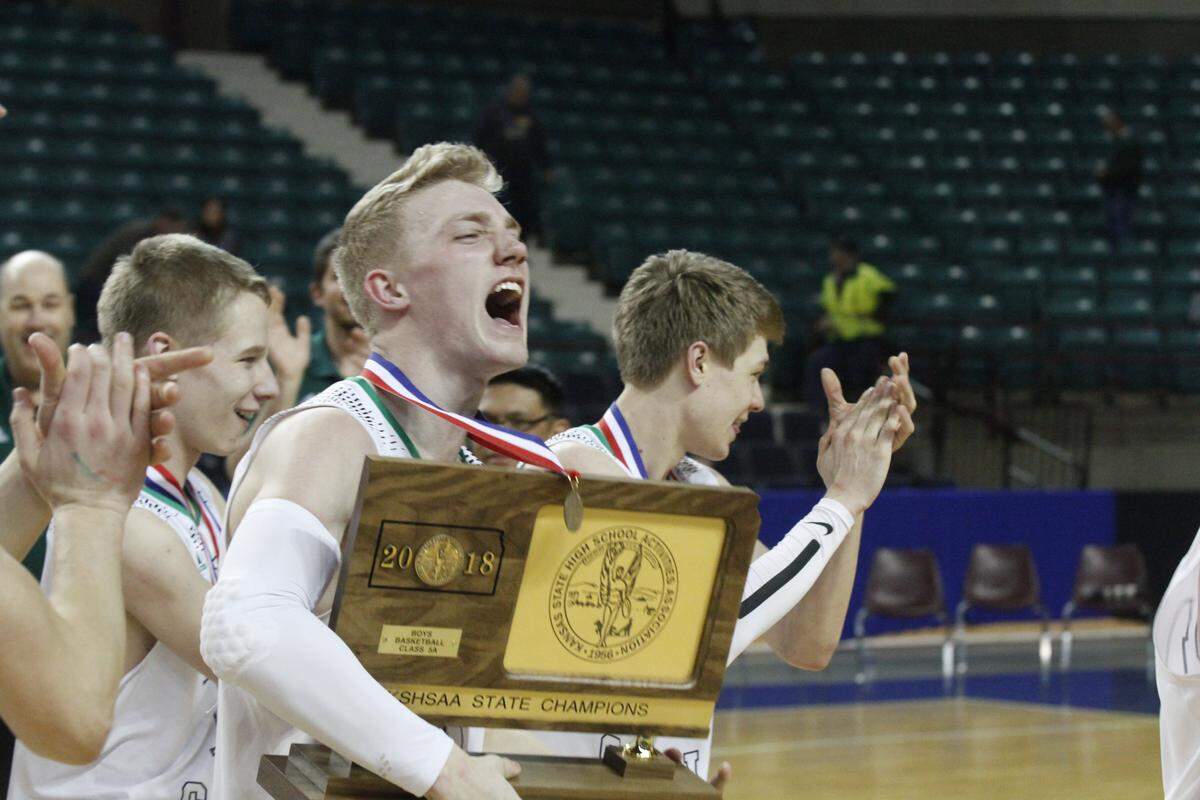 Bishop Carroll senior Luke Evans celebrates after Carroll won the Class 5A boys basketball championship Saturday. The Eagles beat Salina Central 43-41 in overtime at the Kansas Expocentre in Topeka.
