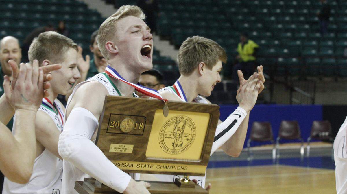 Bishop Carroll senior Luke Evans celebrates after Carroll won the Class 5A boys basketball championship Saturday. The Eagles beat Salina Central 43-41 in overtime at the Kansas Expocentre in Topeka.