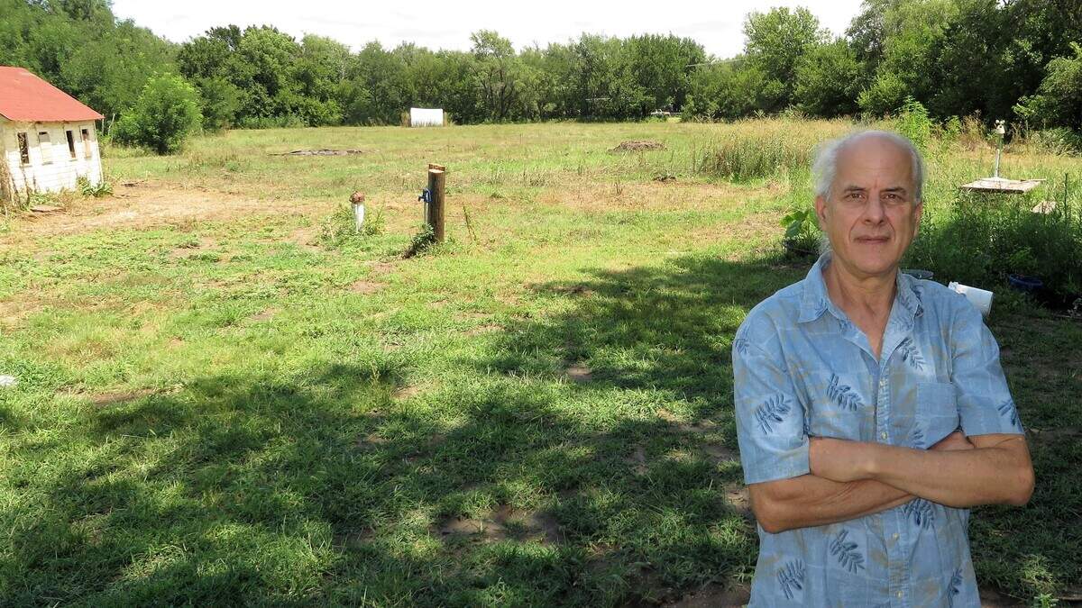 Daniel Wallach stands in front of what had been a field of wildflowers at Birdhouse Farm, until the city of Stafford mowed them down.