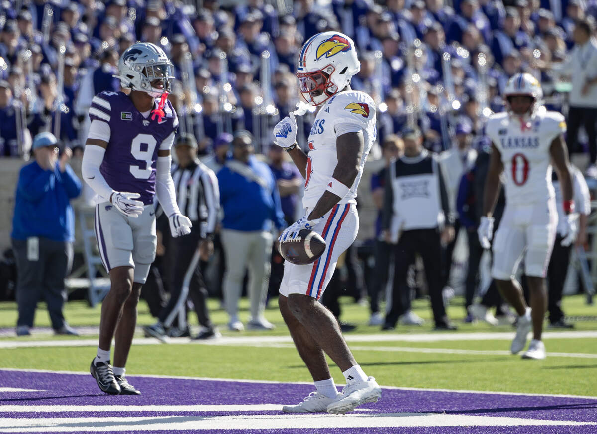 Kansas wide receiver Nik McMillan celebrates a touchdown during the first half of their game against Kansas State in Manhattan on Saturday.