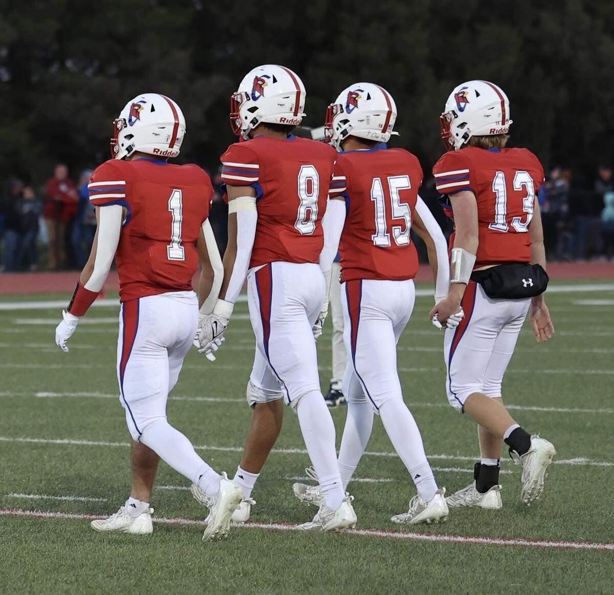 The Cheney senior captains walk onto the field for Friday’s game against Andale.