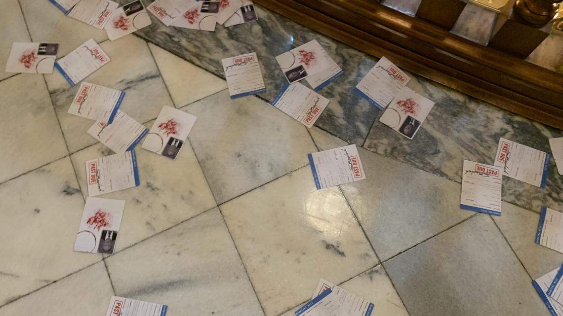 Demonstrators flood Kansas Capitol rotunda with “hospital bills” targeting senators over Medicaid expansion.