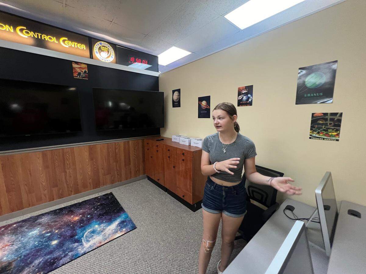 Lilyanne Keyser demonstrates how Mission Control works within the new Space Discovery Institute.