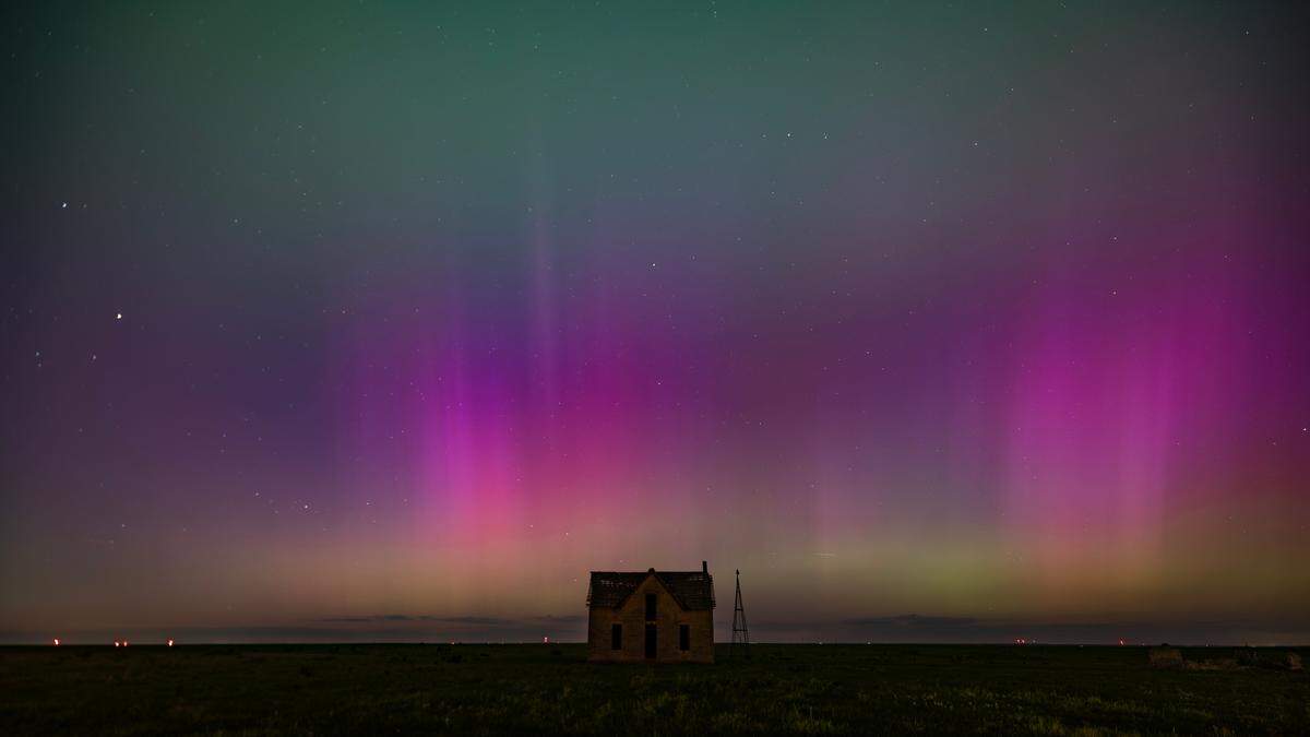 The aurora borealis can be seen in the northern sky near the Marion and Chase County line on Friday night. The abandoned stone limestone house in the pasture was built in 1878.