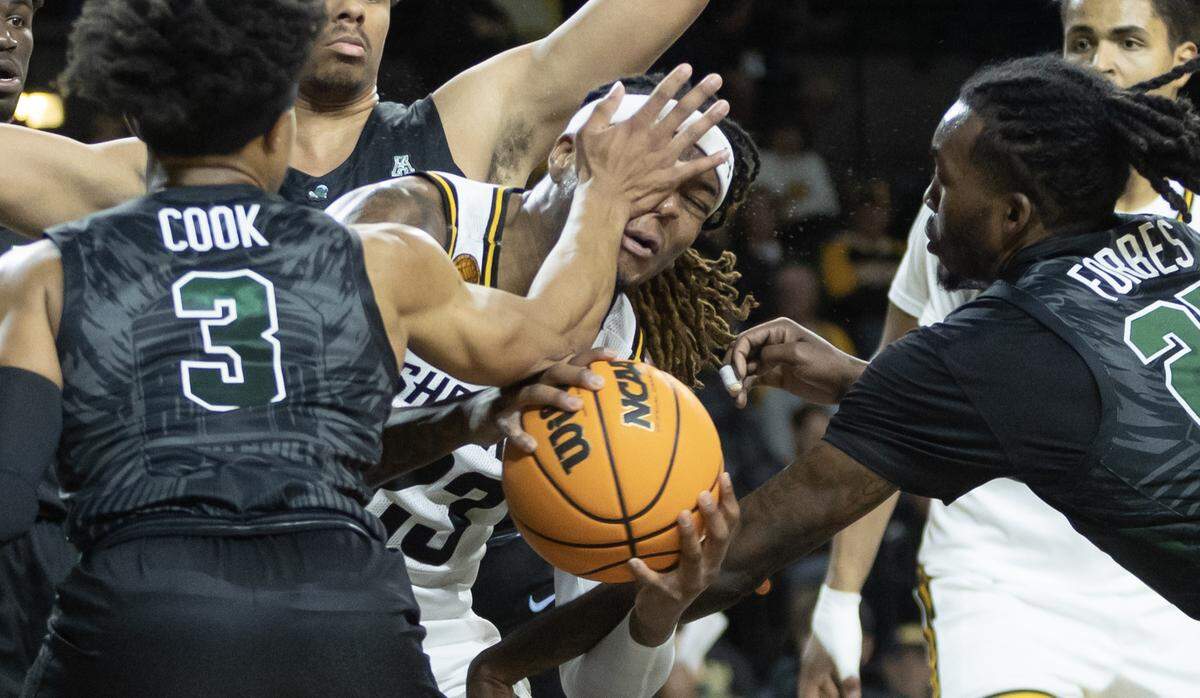 Wichita State’s Gus Okafor is fouled by Tulane’s Jalen Cook during the first half on Wednesday night. Despite holding an 18 point lead in the first half, Wichita lost in overtime 95-90.