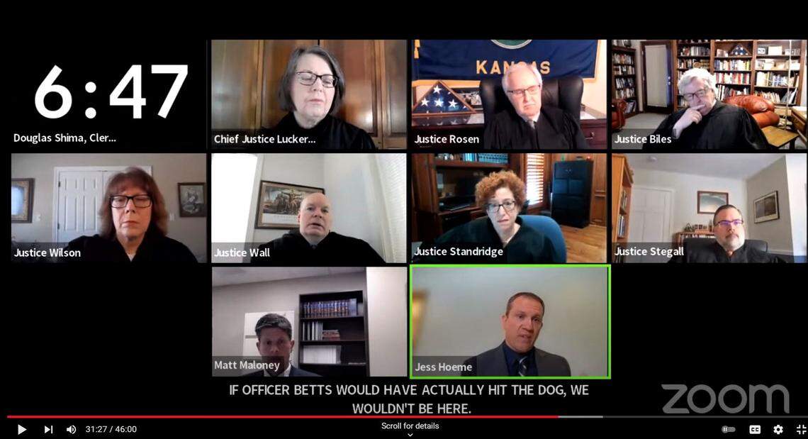 Kansas Supreme Court justices, meeting on Zoom, listen to defense attorney Jess Hoeme, lower right, during oral arguments over a Wichita Police officer can face trial after shooting at a dog and hitting a 9-year-old girl instead.